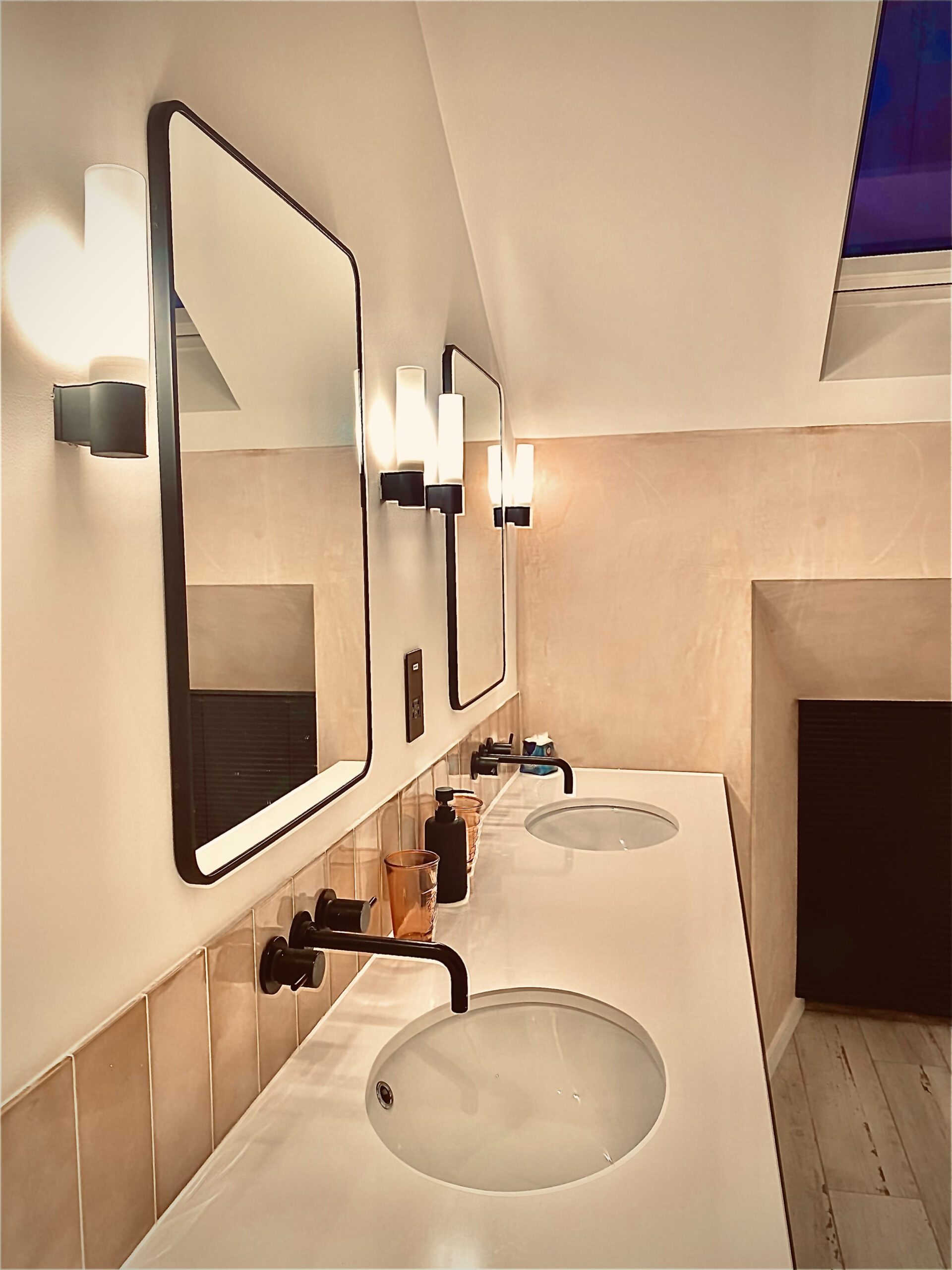 5 tips for lighting a bathroom. A photo of vanity basins with mirrors in a domestic bathroom, specialist lighting designer