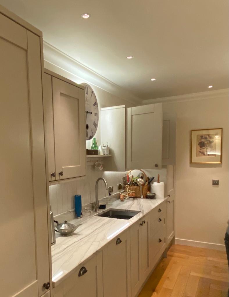 White kitchen with downlighters | Lighting design by Cat Lighting.
