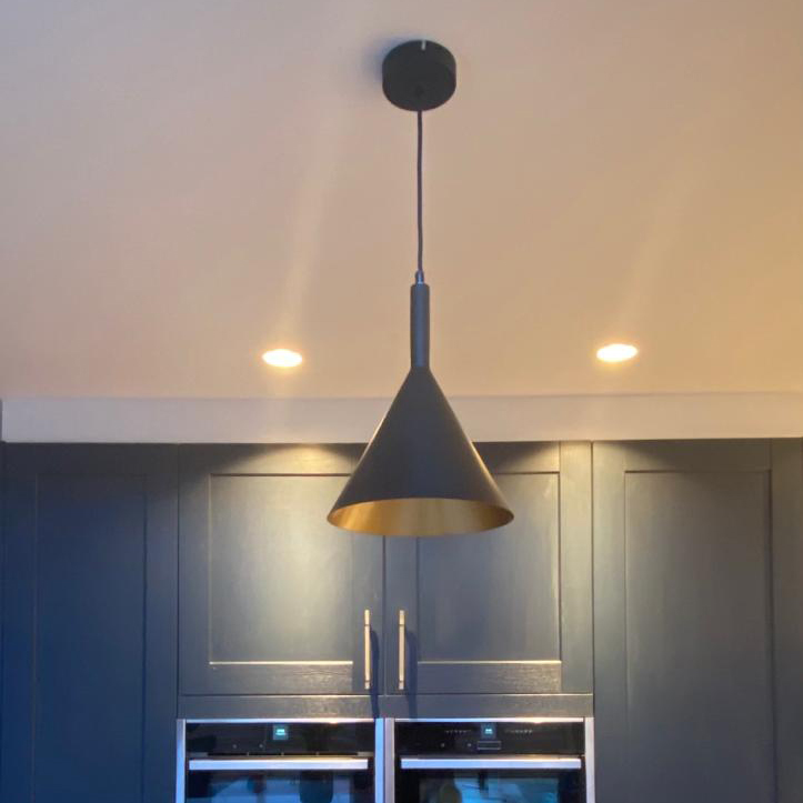 Lighting a kitchen with downlights. A photo of a pendant light and two spot lights in a kitchen